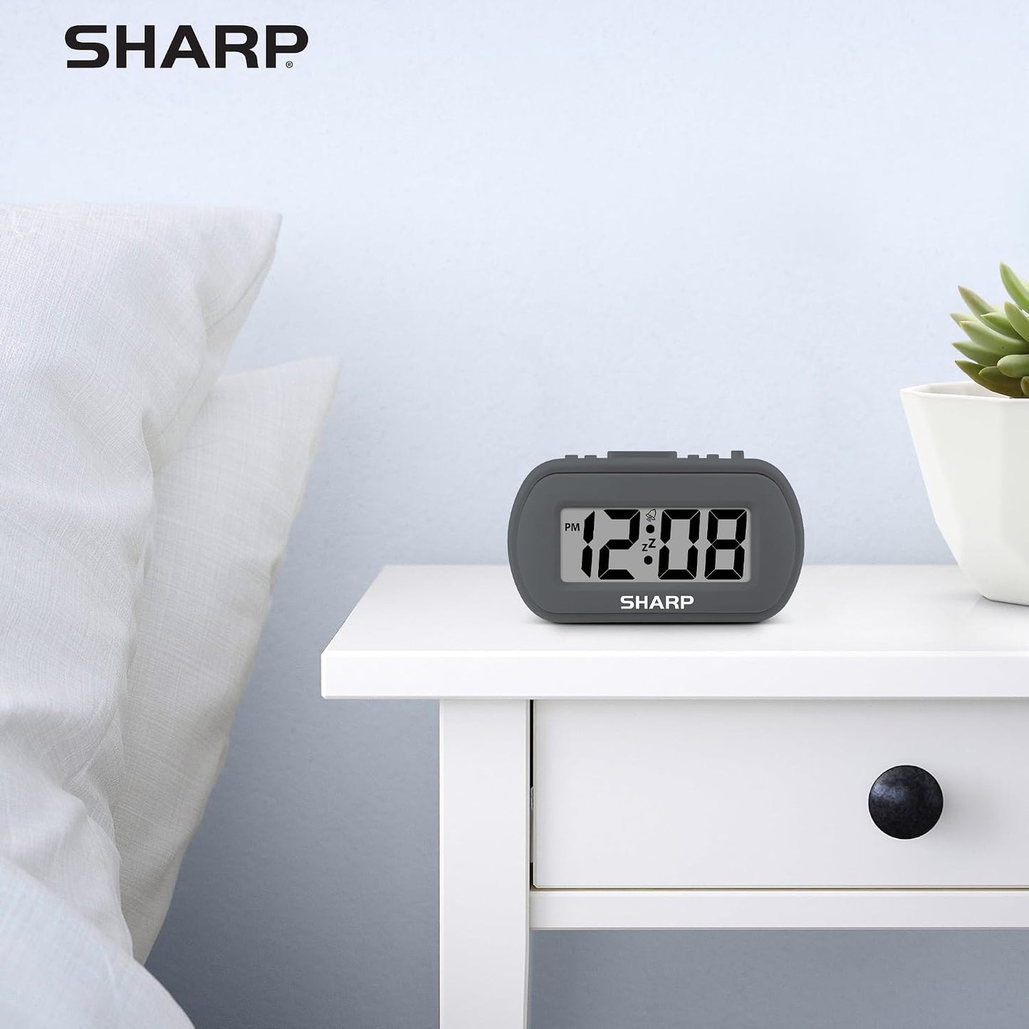 Sharp Battery Alarm Clock, Soft-Touch Case and Backlight, Charcoal Black | Soft-touch rubberized case; Battery operated; Blue backlight on demand; Ascending alarm; Snooze; Easy to use